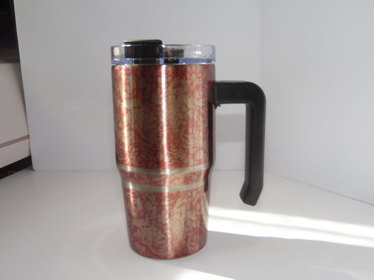 Original photo of reddish-pink patterned grippy cup with silver-colored bands, black handle and clear lid