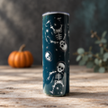 Dark teal skeleton tumbler in a subtly spooky tabletop setting