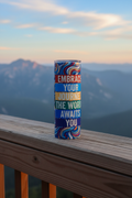 Embrace Your Journey 20 oz skinny tumbler with colorful abstract design in blue, red, gold, and purple and The World Awaits You quote