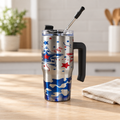 Red and blue star grippy cup with straw on a light wood tabletop